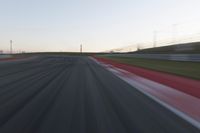 Dawn on the Race Track: Automobiles Against a Clear Sky