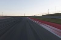 Dawn on the Race Track: Automobiles Against a Clear Sky