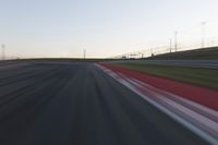 Dawn on the Race Track: Automobiles Against a Clear Sky