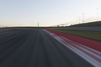 Dawn on the Race Track: Automobiles Against a Clear Sky