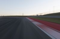 Dawn on the Race Track: Automobiles Against a Clear Sky