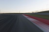 Dawn on the Race Track: Automobiles Against a Clear Sky