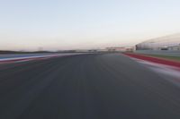 a race track with the front end blurredd out with blurry lines from a car