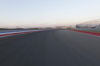 a race track with the front end blurredd out with blurry lines from a car