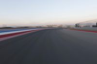 a race track with the front end blurredd out with blurry lines from a car