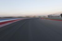 a race track with the front end blurredd out with blurry lines from a car