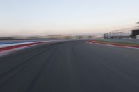 a race track with the front end blurredd out with blurry lines from a car