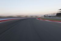 a race track with the front end blurredd out with blurry lines from a car