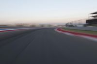 a race track with the front end blurredd out with blurry lines from a car