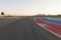 Dawn at the Race Track: A Red Stadium in Clear Sky