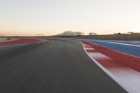 Dawn at the Race Track: A Red Stadium in Clear Sky