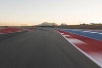 Dawn at the Race Track: A Red Stadium in Clear Sky