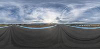 three identical images of a large body of water, a track and a sky filled with clouds