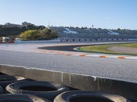 the green road and orange and white stripe line at an event near the racetrack and stadium