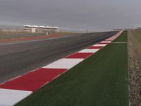 an airport runway next to a field and buildings with a long strip that says silver, red, and white