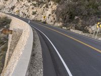 this is the image of a mountain road with trees and rocks on both sides of it