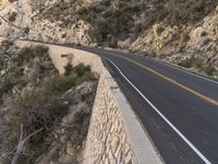 this is the image of a mountain road with trees and rocks on both sides of it