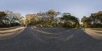 three shots showing different angles of a road with a car, trees and dirt in the background