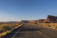 Dawn Road Through Desert Asphalt