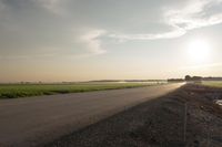 Dawn in Rural Canada: Sun and Asphalt Road