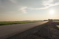 Dawn in Rural Canada: Sun and Asphalt Road