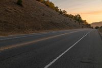 Dawn Over Rural Highland Landscape with Asphalt Road