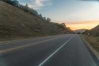 Dawn Over Rural Highland Landscape with Asphalt Road