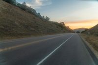 Dawn Over Rural Highland Landscape with Asphalt Road