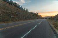 Dawn Over Rural Highland Landscape with Asphalt Road