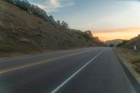 Dawn Over Rural Highland Landscape with Asphalt Road