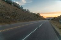 Dawn Over Rural Highland Landscape with Asphalt Road