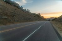 Dawn Over Rural Highland Landscape with Asphalt Road