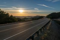 Dawn on a Rural Mountain Road: Sunlight Breaking Through Clouds