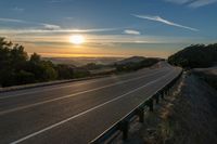 Dawn on a Rural Mountain Road: Sunlight Breaking Through Clouds