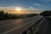 Dawn on a Rural Mountain Road: Sunlight Breaking Through Clouds