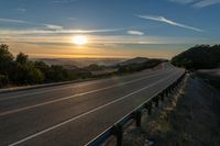 Dawn on a Rural Mountain Road: Sunlight Breaking Through Clouds