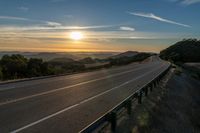 Dawn on a Rural Mountain Road: Sunlight Breaking Through Clouds