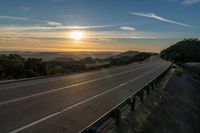 Dawn on a Rural Mountain Road: Sunlight Breaking Through Clouds