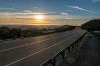 Dawn on a Rural Mountain Road: Sunlight Breaking Through Clouds