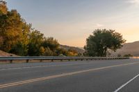 Dawn on a Rural Road: A Majestic Mountain View