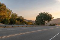 Dawn on a Rural Road: A Majestic Mountain View