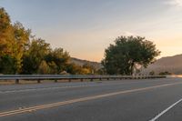 Dawn on a Rural Road: A Majestic Mountain View