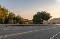 Dawn on a Rural Road: A Majestic Mountain View