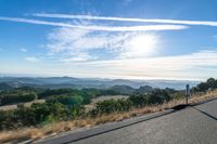 Dawn Sunlight over Highland Landscape with Asphalt Road