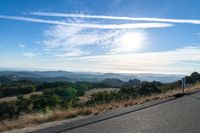 Dawn Sunlight over Highland Landscape with Asphalt Road