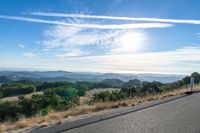 Dawn Sunlight over Highland Landscape with Asphalt Road