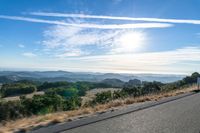 Dawn Sunlight over Highland Landscape with Asphalt Road