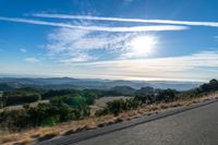 Dawn Sunlight over Highland Landscape with Asphalt Road