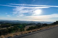 Dawn Sunlight over Highland Landscape with Asphalt Road