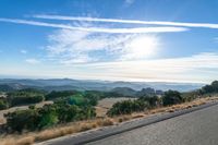 Dawn Sunlight over Highland Landscape with Asphalt Road